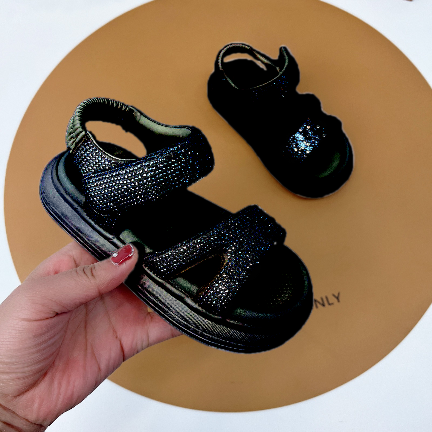 "Fashionable girls' sandals with an elegant shine and comfortable design"