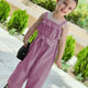"Stylish girls' jumpsuit with a waist belt - perfect for summer occasions"