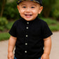Stylish kids' outfit with a modern design, featuring a button-up shirt and denim shorts – perfect for a comfortable and coordinated look on sunny days!